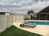 6 foot tall solid vinyl privacy fence enclosing a pool area