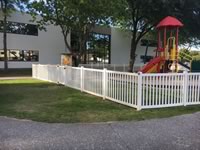 4 foot tall closed picket vinyl fence around a play ground
